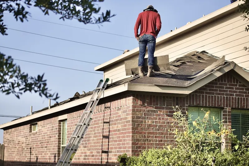 Professional roofer working on a residential roof in Westdale